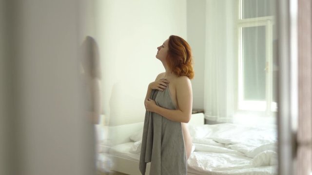 Redhead woman's lazy morning in a sunny vintage room with no clothes and naked body parts - Holding grey towel