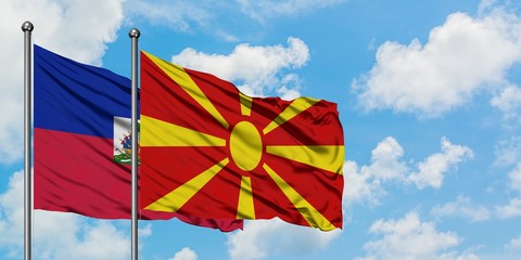 Haiti and Macedonia flag waving in the wind against white cloudy blue sky together. Diplomacy concept, international relations.