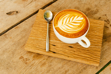 Close up of Hot coffee cups with spoon on wooden plate