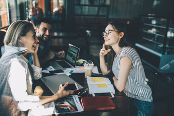 Laughing young students in cafe