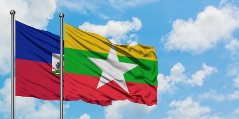 Haiti and Myanmar flag waving in the wind against white cloudy blue sky together. Diplomacy concept, international relations.