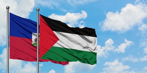 Haiti and Palestine flag waving in the wind against white cloudy blue sky together. Diplomacy concept, international relations.