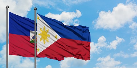 Haiti and Philippines flag waving in the wind against white cloudy blue sky together. Diplomacy concept, international relations.