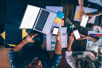 Coworkers addicted with smartphones sitting in cafe