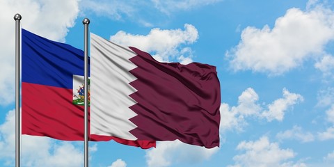 Haiti and Qatar flag waving in the wind against white cloudy blue sky together. Diplomacy concept, international relations.