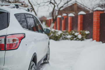 white car SUV in the winter yard, rear view 