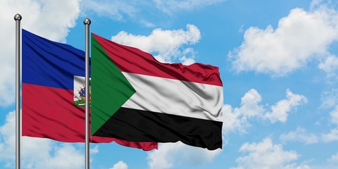 Haiti and Sudan flag waving in the wind against white cloudy blue sky together. Diplomacy concept, international relations.