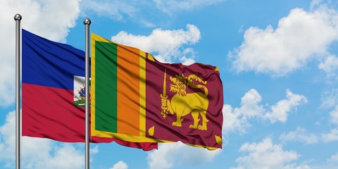 Haiti and Sri Lanka flag waving in the wind against white cloudy blue sky together. Diplomacy concept, international relations.