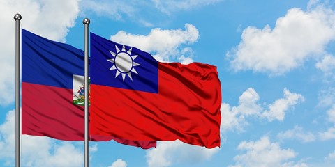Haiti and Taiwan flag waving in the wind against white cloudy blue sky together. Diplomacy concept, international relations.