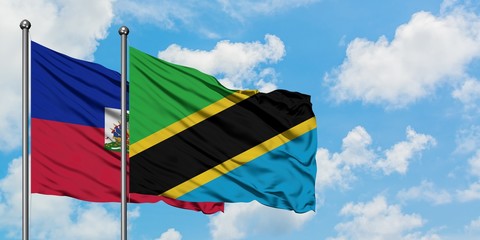 Haiti and Tanzania flag waving in the wind against white cloudy blue sky together. Diplomacy concept, international relations.