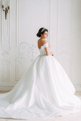 Fototapeta premium European-style wedding at the hotel. Bride in a white dress in the interior Studio.