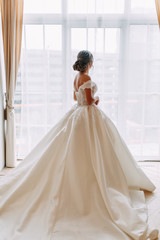 Fototapeta premium European-style wedding at the hotel. Bride in a white dress in the interior Studio.