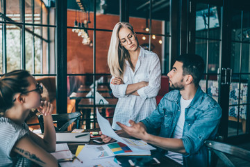 Serious coworking people with charts in cafe