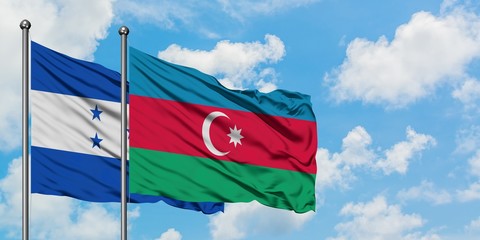 Honduras and Azerbaijan flag waving in the wind against white cloudy blue sky together. Diplomacy concept, international relations.