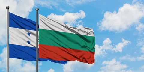 Honduras and Bulgaria flag waving in the wind against white cloudy blue sky together. Diplomacy concept, international relations.
