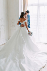 Naklejka premium Modern ceremony in European style. Beautiful wedding couple in atmospheric forest with rocks.