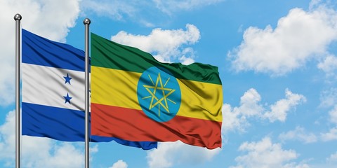 Honduras and Ethiopia flag waving in the wind against white cloudy blue sky together. Diplomacy concept, international relations.