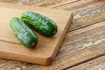 Just picked cucumbers lying on cutting board.