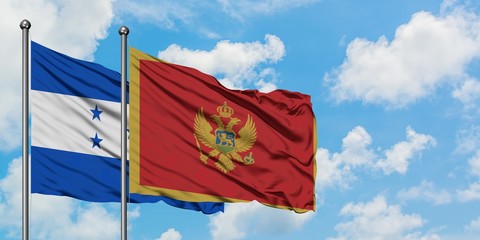 Honduras and Montenegro flag waving in the wind against white cloudy blue sky together. Diplomacy concept, international relations.