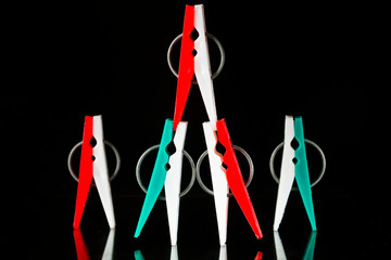 Multi-colored clothespins on a black background.