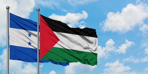 Honduras and Palestine flag waving in the wind against white cloudy blue sky together. Diplomacy concept, international relations.