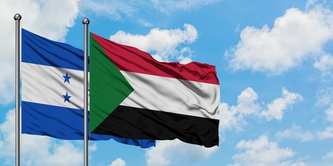 Honduras and Sudan flag waving in the wind against white cloudy blue sky together. Diplomacy concept, international relations.