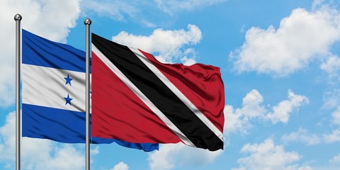 Honduras and Trinidad And Tobago flag waving in the wind against white cloudy blue sky together. Diplomacy concept, international relations.