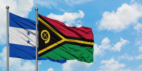 Honduras and Vanuatu flag waving in the wind against white cloudy blue sky together. Diplomacy...