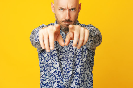 I Choose You Concept. Close Up Portrait Of Charismatic 40 Years Old Man Standing Over Yellow Background Showing Finger Sign. Serious Face. Text-space. Studio Shot