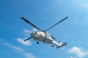 Military navy helicopter flying above the ocean.Copy space and background.
