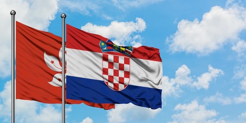 Hong Kong and Croatia flag waving in the wind against white cloudy blue sky together. Diplomacy concept, international relations.