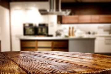 Wooden table background of free space for your decoration and blurred background of kitchen. Copy...