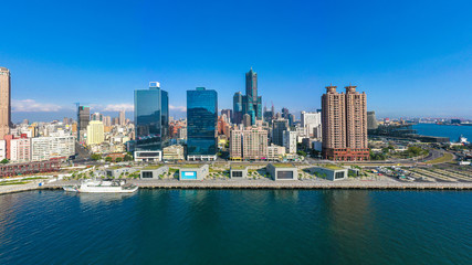 Fototapeta na wymiar Aerial view Kaohsiung city with blue sky background and Kaohsiung harbor, Taiwan.