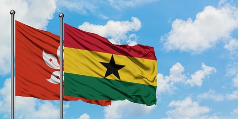 Hong Kong and Ghana flag waving in the wind against white cloudy blue sky together. Diplomacy concept, international relations.