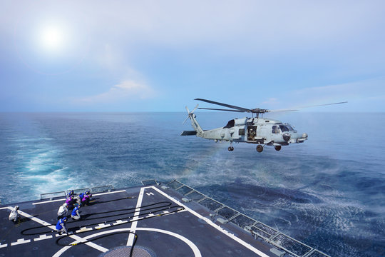 Military Helicopter Flying Above The War Ship  Above The Ocean. Dangerous During Work And Safety For Work Concept.