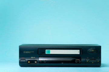 VHS video recorder Retro video recorder with video cassette on a light background .