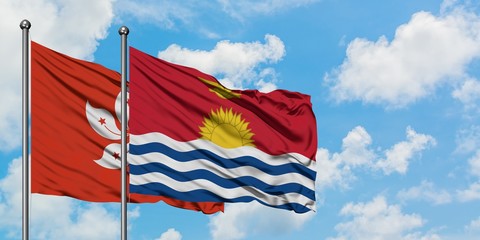 Hong Kong and Kiribati flag waving in the wind against white cloudy blue sky together. Diplomacy concept, international relations.