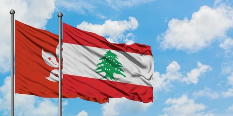 Hong Kong and Lebanon flag waving in the wind against white cloudy blue sky together. Diplomacy concept, international relations.