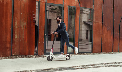 Happy hipster riding electric scooter © kegfire