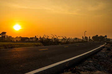 Roads and rice paddies during the sunrise time.