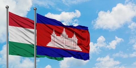 Hungary and Cambodia flag waving in the wind against white cloudy blue sky together. Diplomacy concept, international relations.