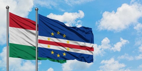 Hungary and Cape Verde flag waving in the wind against white cloudy blue sky together. Diplomacy concept, international relations.