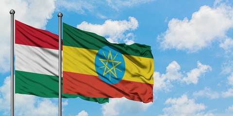 Hungary and Ethiopia flag waving in the wind against white cloudy blue sky together. Diplomacy concept, international relations.