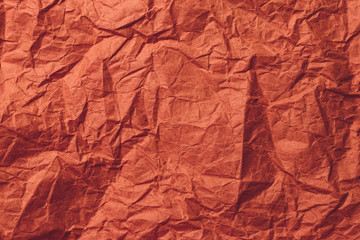 Red wrapping paper, crumpled paper texture. Creased sheet background. 