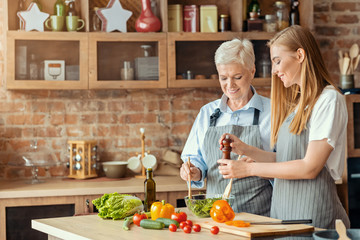 Beautiful mother and daughter cooking healthy food together