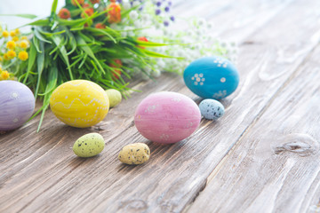 Fototapeta na wymiar Easter eggs painted in pastel colors on a wooden background