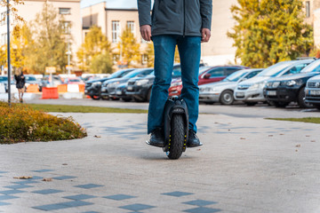 Man Riding On Electric Unicycle On Street, Personal Electric Transport Technology, Autumn Day