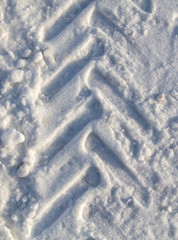 Traces of a car on white snow