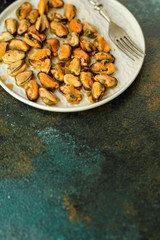mussels in oil (delicious seafood) portion serving. top food background. copy space
