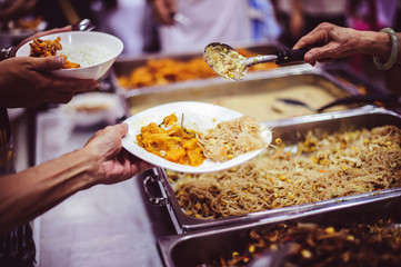 The poor who get hungry get free food donations from volunteers who come to serve : the concept of helping and hunger